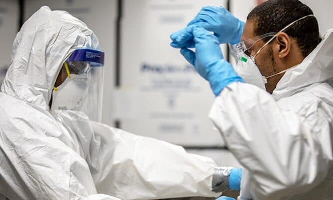 Healthcare workers checking protective gear