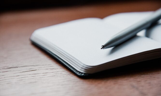 photo of a journal and a pen