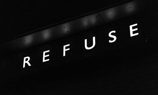 White letters spelling "Refuse" on a black background