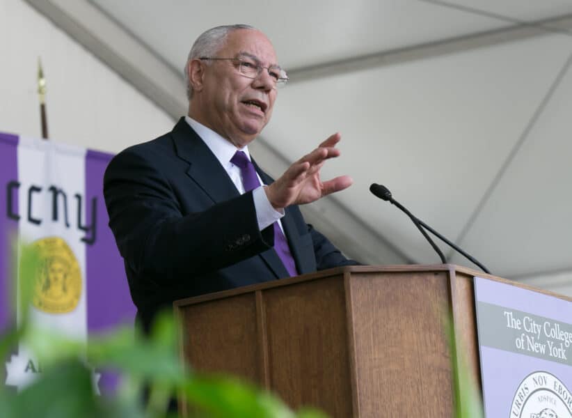 Powell speaking behind a podium.
