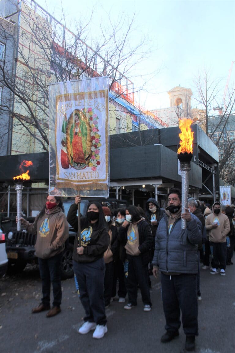 Parishioners line up in three lines.