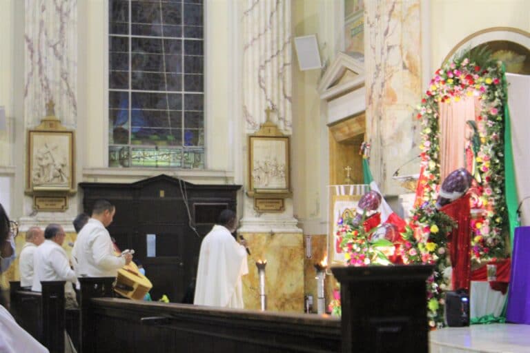 Father serenading the Virgin of Guadalupe with mariachi.