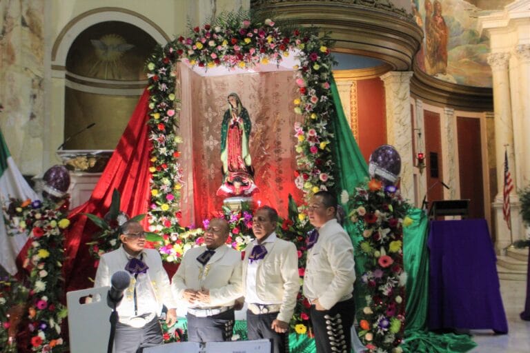 El Mariachi Bustamante pose in front of the alter.