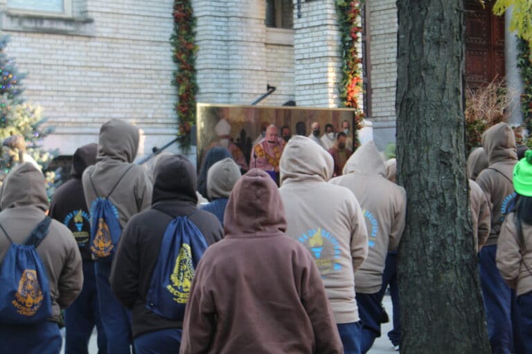 Parishioners watch the live mass on televisions outside the church.