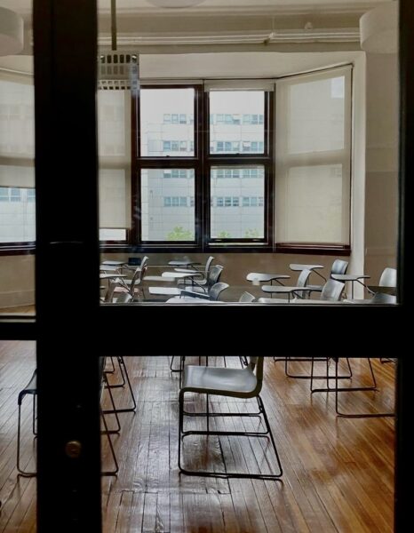Perspective of empty chairs in a classroom.