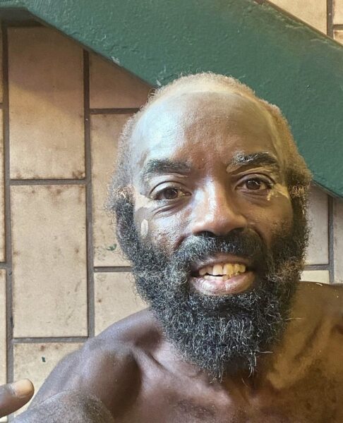 Selfie photo of a man pointing at himself.