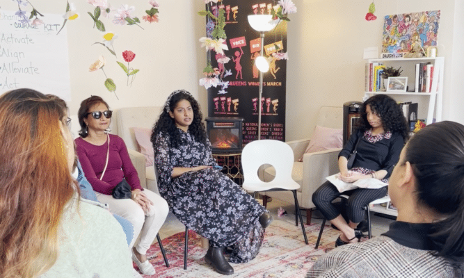 Women talking in a group at the South Queens Women's March office